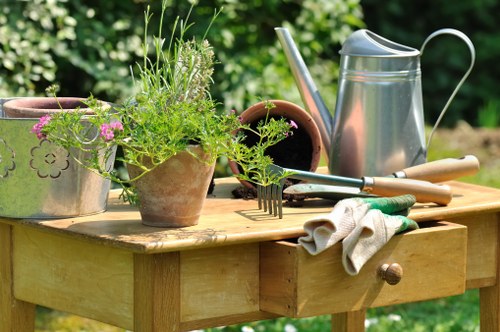 Insured Ponders End gardening team working safely with tools and protective gear